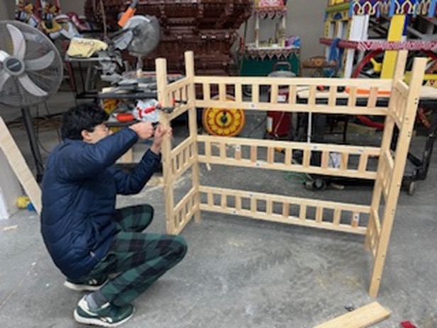 Working on the 4-tier wooden cart structure