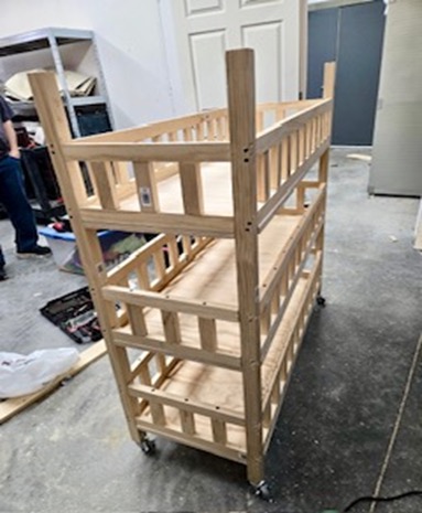 Completed 4-tier wooden utility cart with wheels